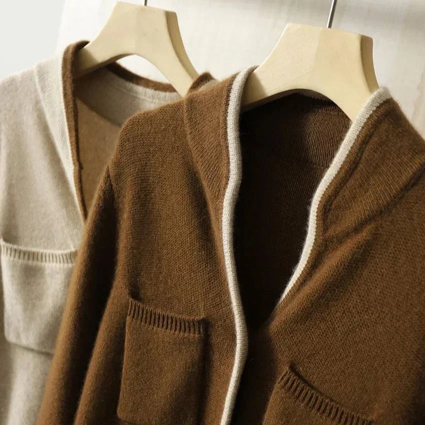 Londyn vintage cardigan in beige draped over a chair showing fabric texture and warm neutral tone