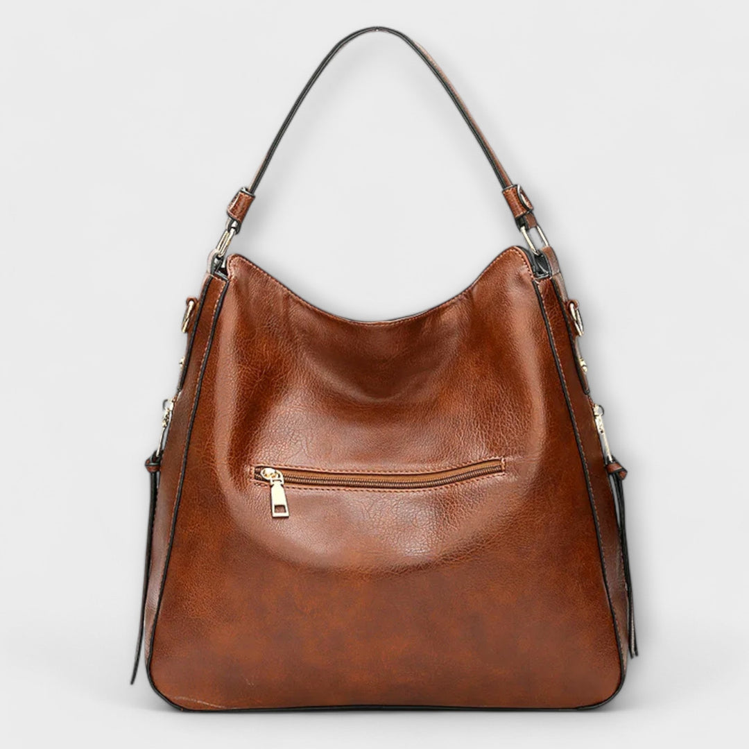 Lora shoulder bag in blue showing interior compartments and organized layout