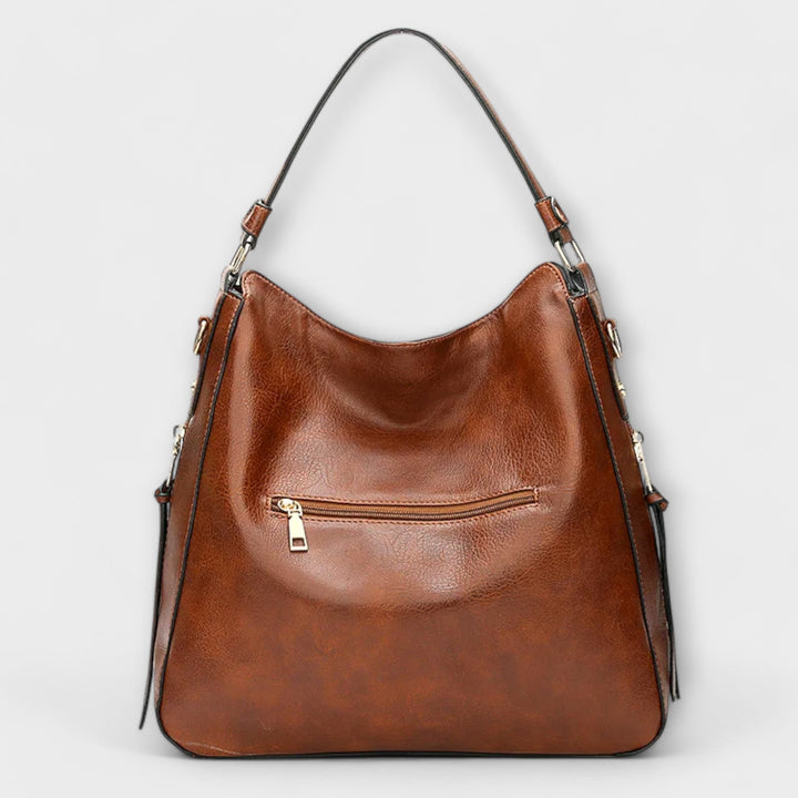 Lora shoulder bag in blue showing interior compartments and organized layout