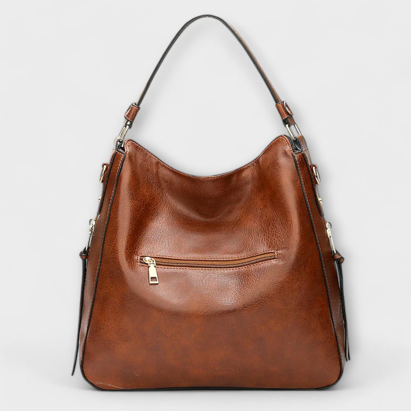 Lora shoulder bag in blue showing interior compartments and organized layout