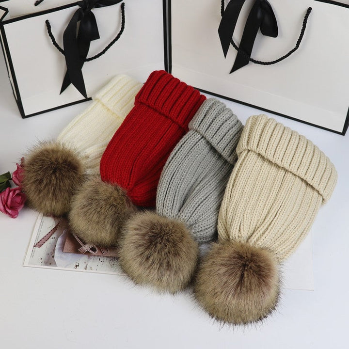 Close-up of the fluffy pom detail on the Lorette knit beanie in khaki