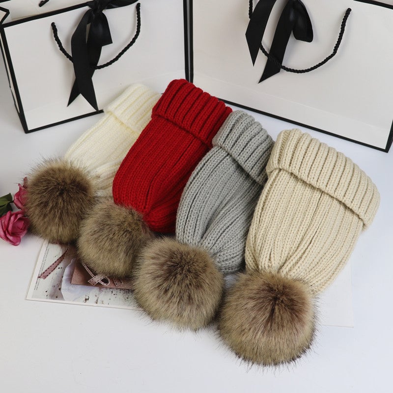 Close-up of the fluffy pom detail on the Lorette knit beanie in khaki