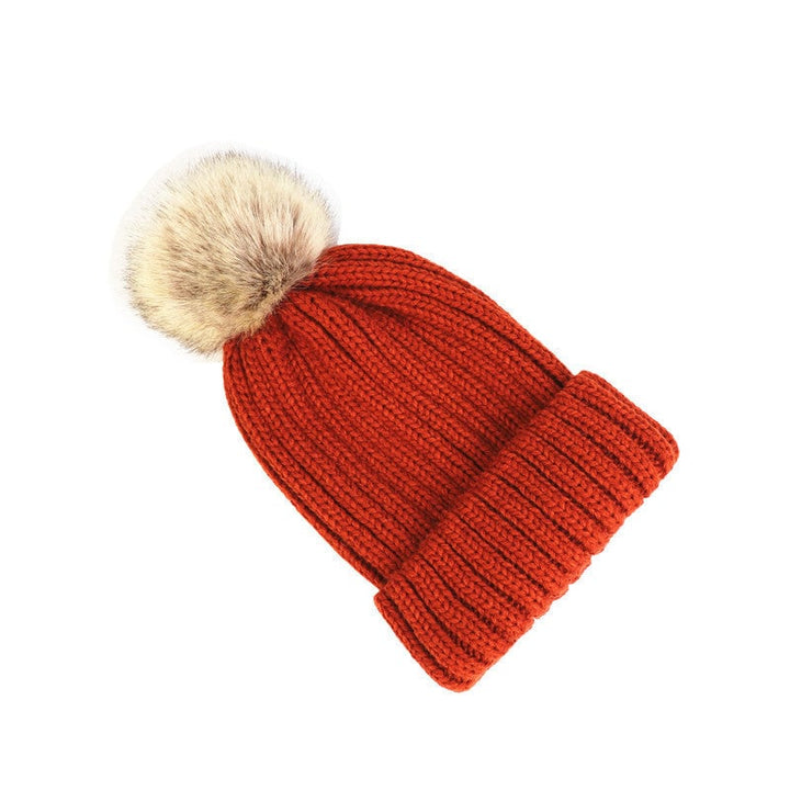 Side profile of a woman wearing the Lorette beanie in claret red
