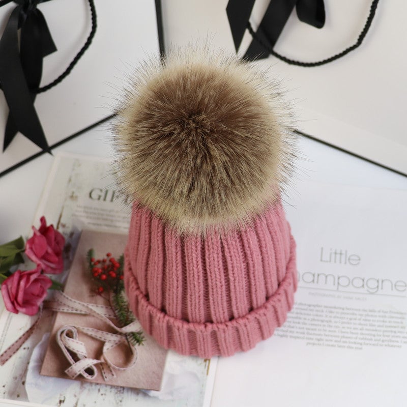 Lorette knit beanie in rose red styled with a winter coat