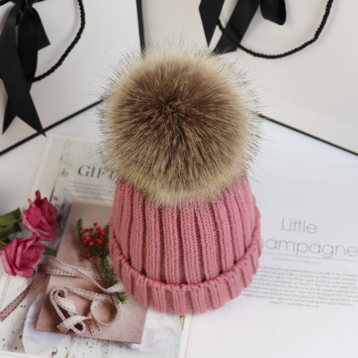 Lorette knit beanie in rose red styled with a winter coat