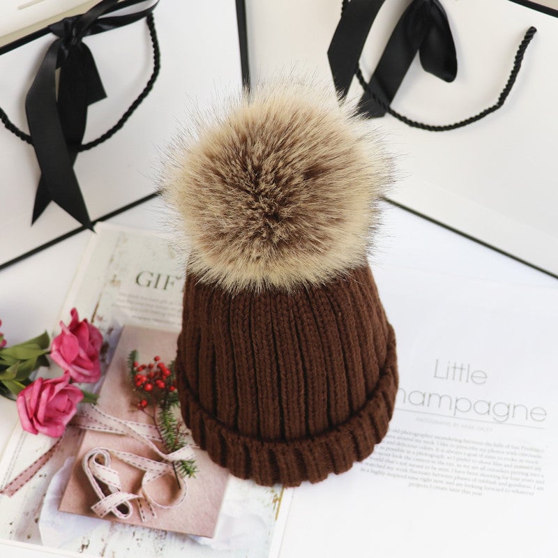 Lorette beanie in navy styled with a wool coat and scarf