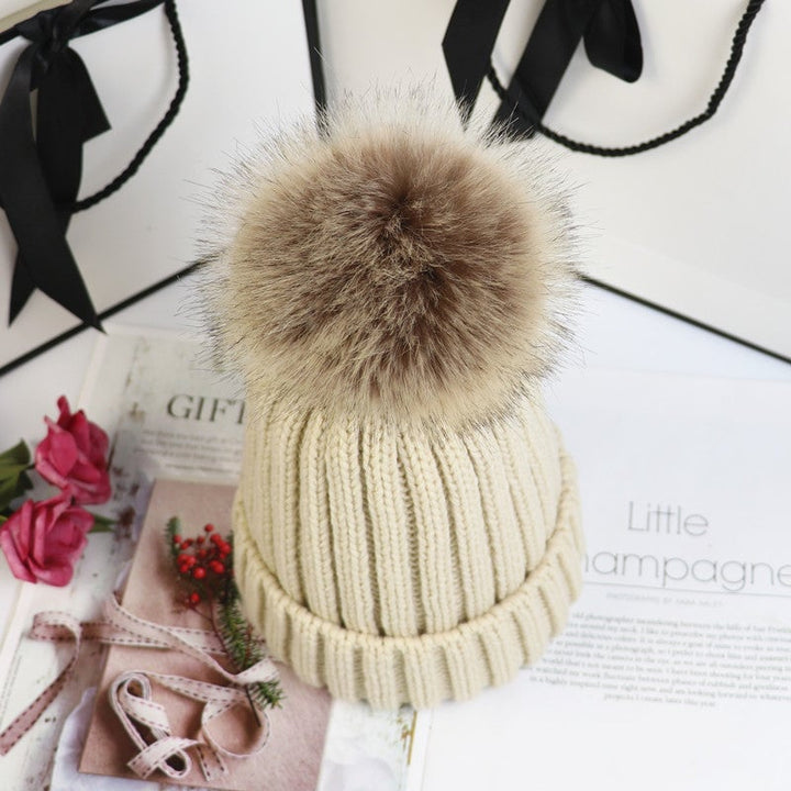 Close-up of the ribbed cuff detail on the Lorette knit beanie in beige