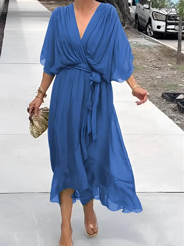 Close-up of the wrap neckline and waist tie detail on a lightweight midi dress