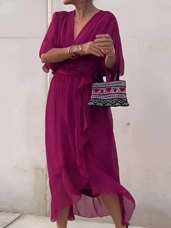 Detail shot of the adjustable tie waist on a wrap midi dress in a rich color option