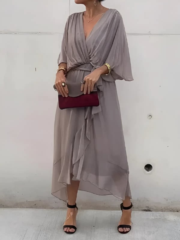 Woman posing in a wrap midi dress demonstrating its versatile and polished everyday style
