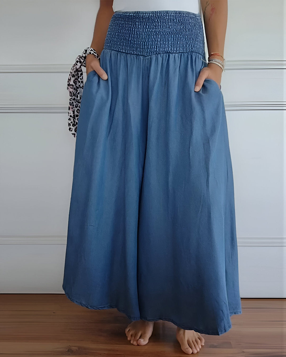 Woman wearing Lorraine elastic waist pants in blue, relaxed fit, front view