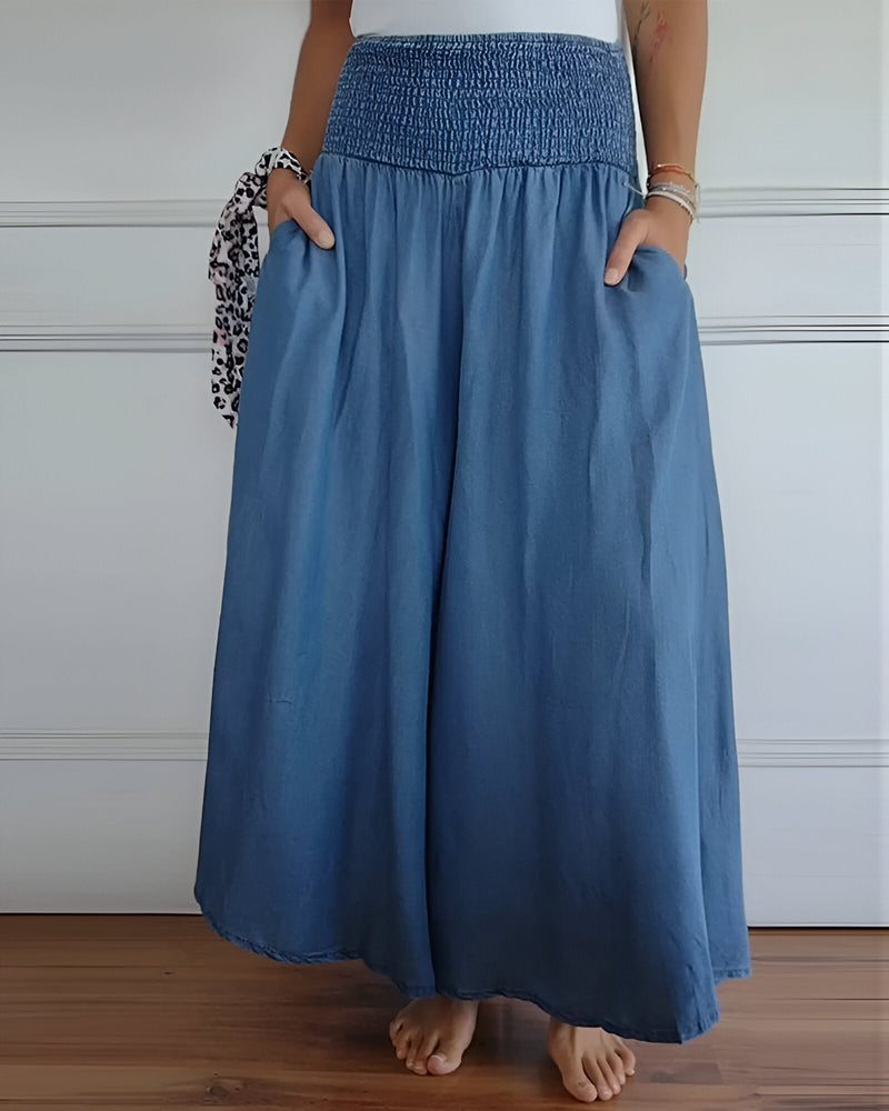 Woman wearing Lorraine elastic waist pants in blue, relaxed fit, front view