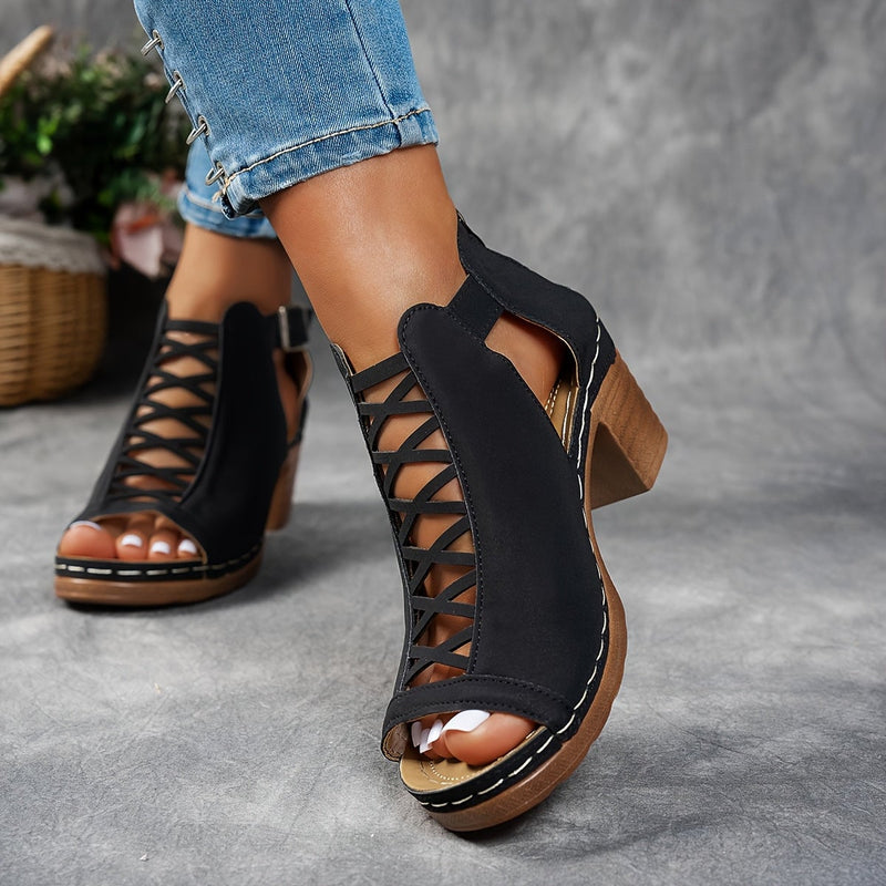 Close-up of Lotus sandal lattice heel and adjustable strap in black