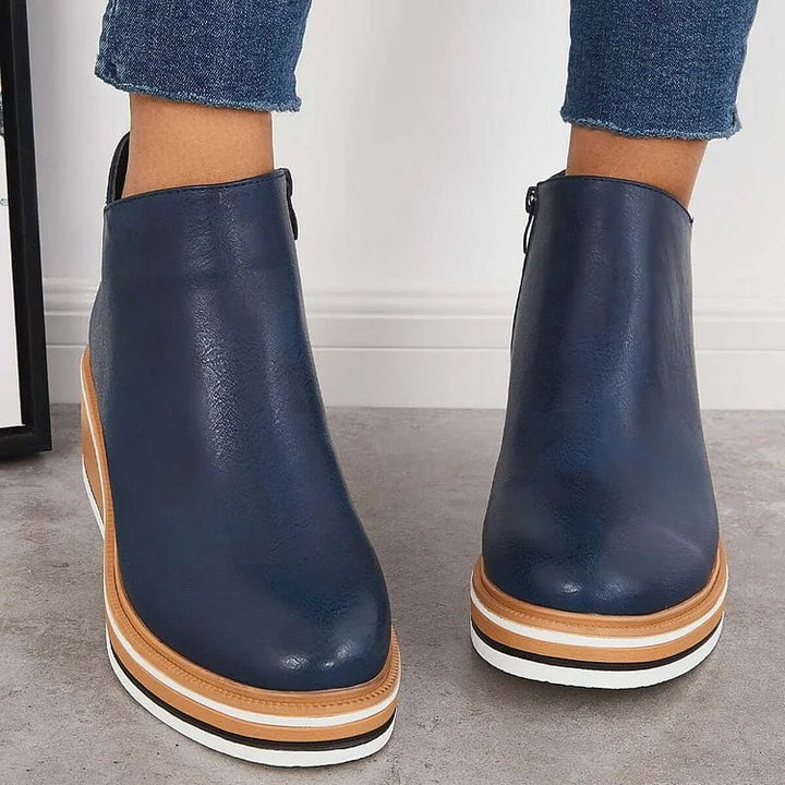 Side profile of the Lucille modern luxe boot highlighting the non-slip sole and sleek silhouette
