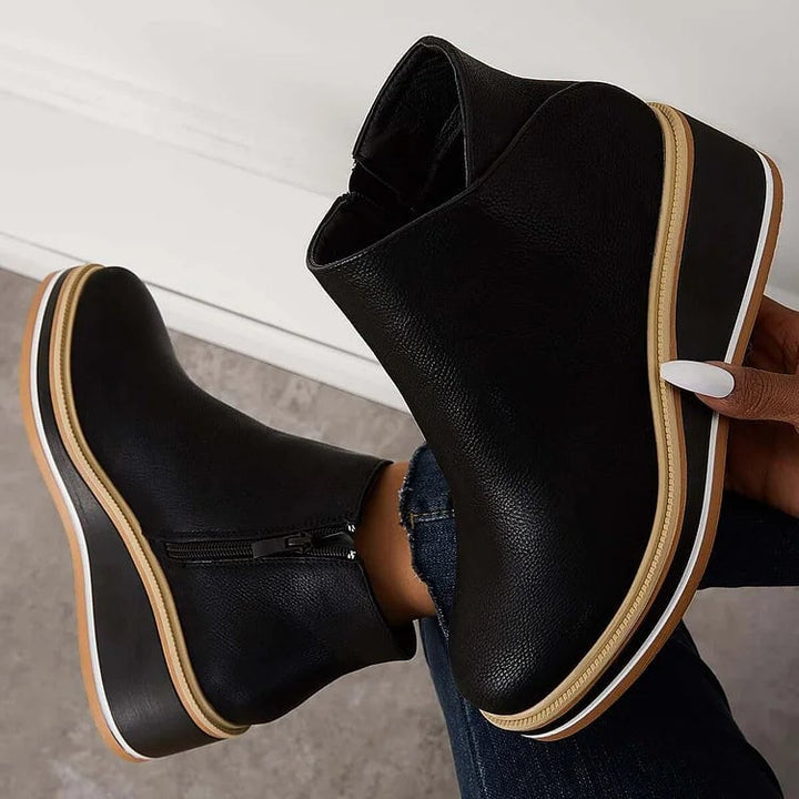Lucille boots in blue shown from the back highlighting heel height and construction
