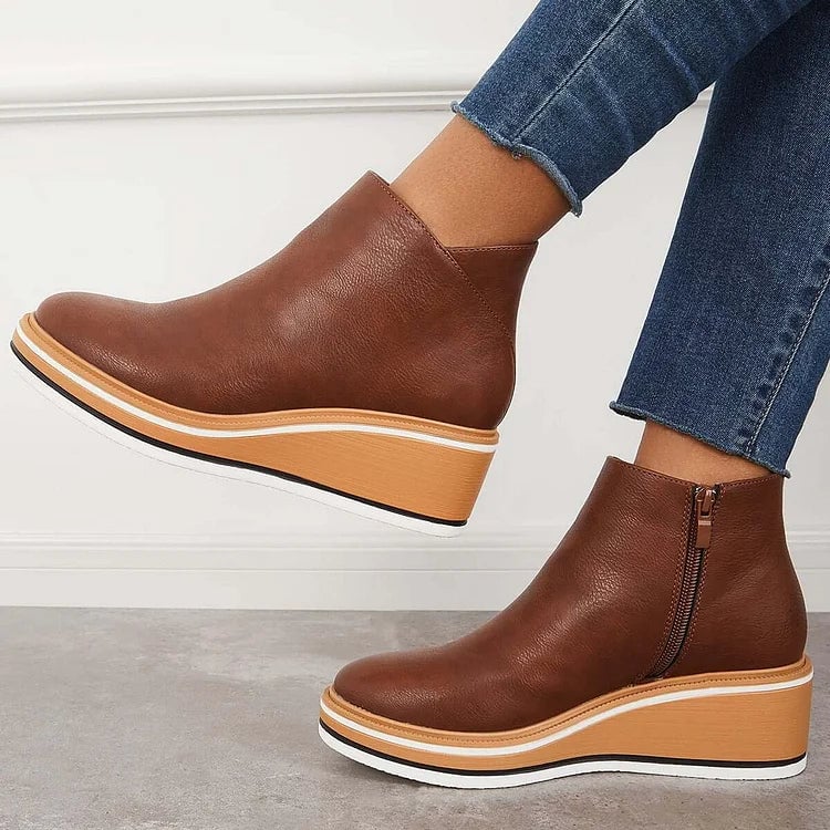 Pair of Lucille blue boots on a white shelf in a bright lifestyle setting