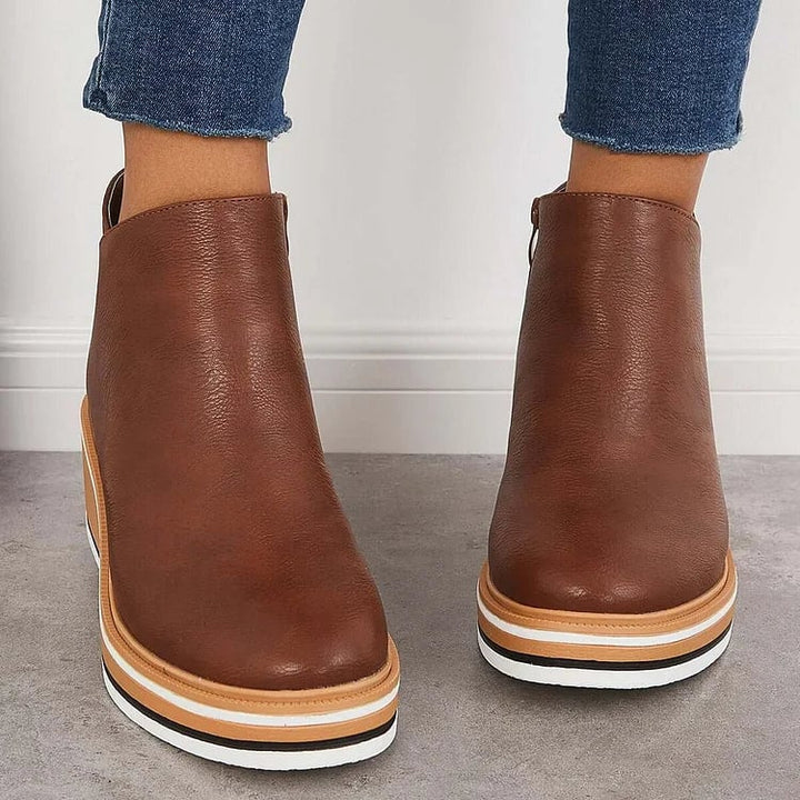 Size chart reference lifestyle shot of Lucille modern luxe boots next to a measuring tape