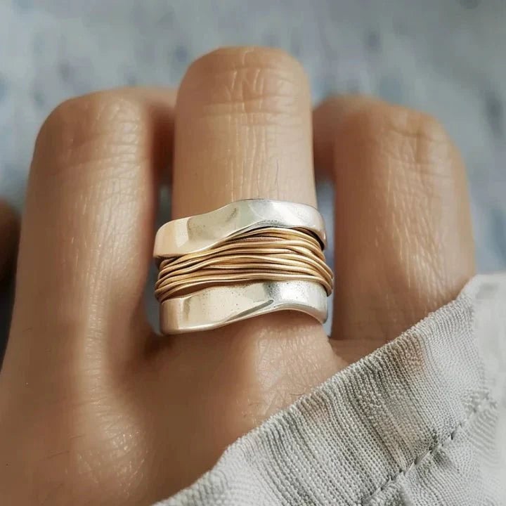 Two-tone statement ring with a modern dual-finish design, shown in a close-up product view