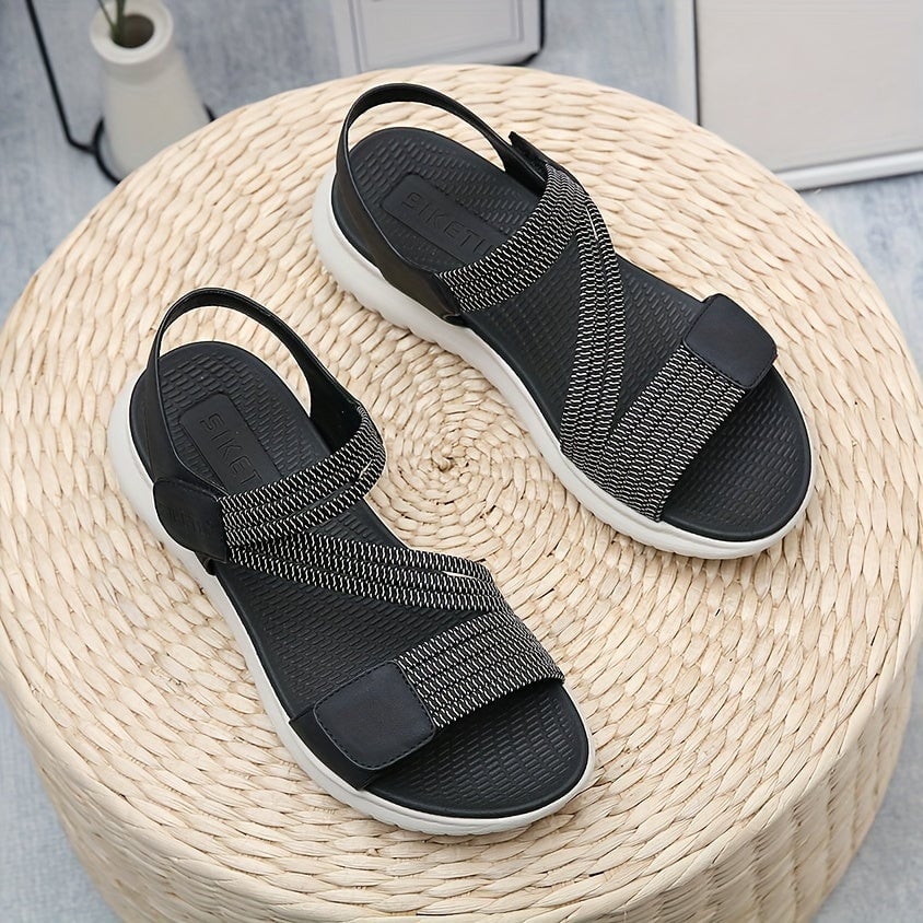 Luna sandal worn on foot, standing on neutral surface