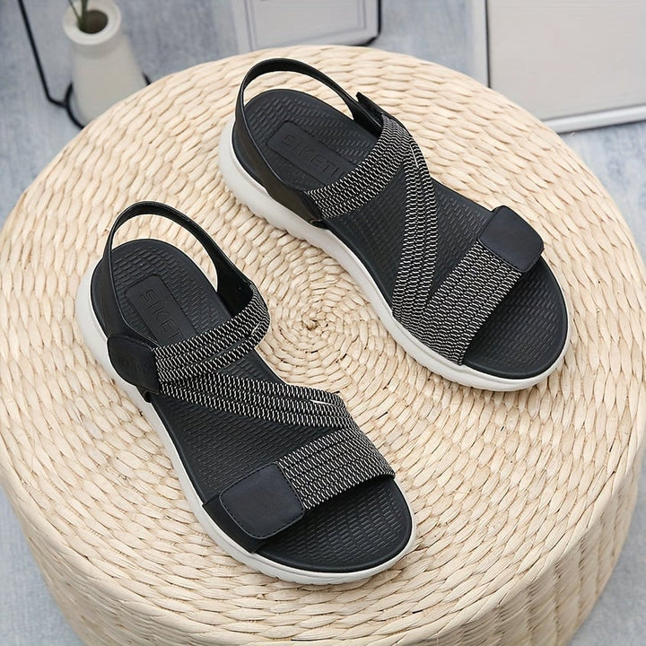 Luna sandal worn on foot, standing on neutral surface