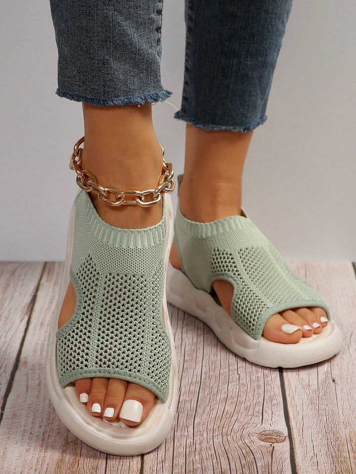 Luna platform sandals in print black worn on feet, open toe detail visible