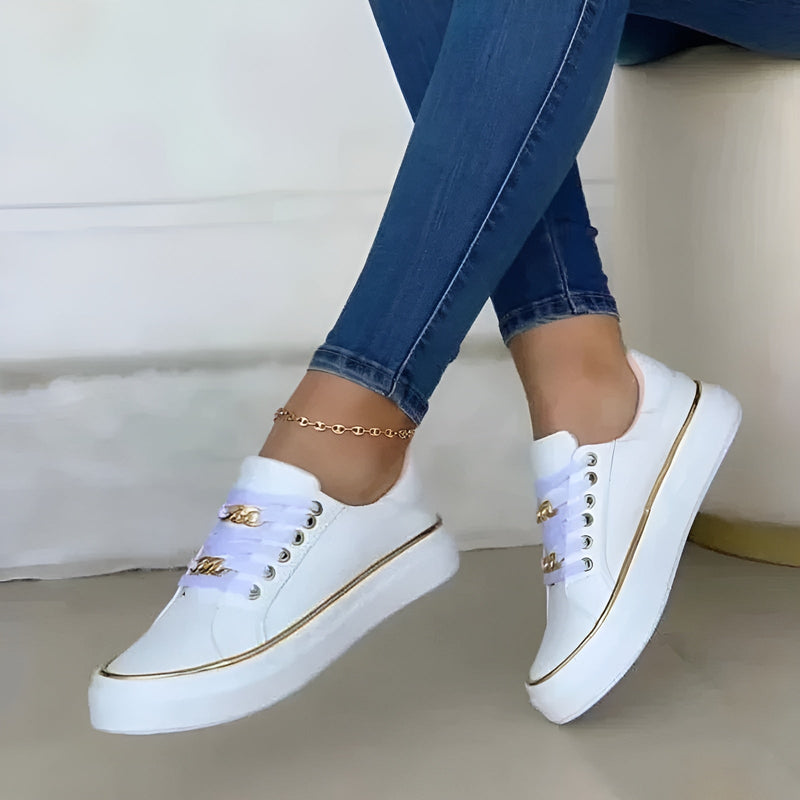 White women's platform sneaker with gold chain eyelet hardware and lavender ribbon laces, front three-quarter view