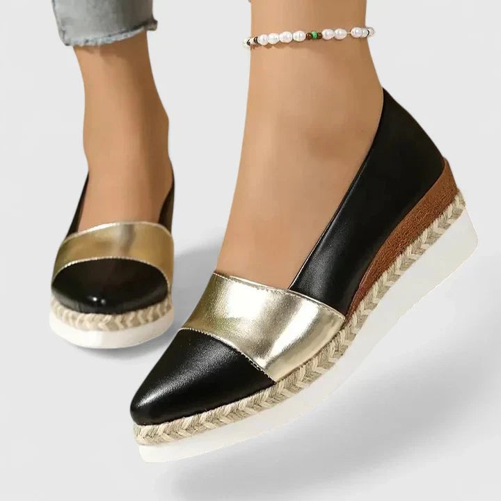 Close-up of two-tone metallic upper and woven espadrille sole on Luna wedge loafers