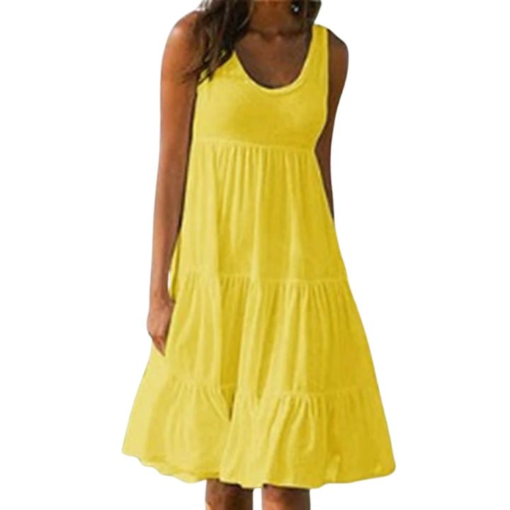 Luna tiered midi dress in green worn outdoors, falling just below the knee in a relaxed boho style