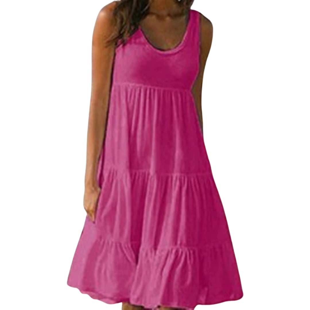 Model wearing the Luna ruffle midi dress in pink, accessorized with hoop earrings and a wide-brim hat