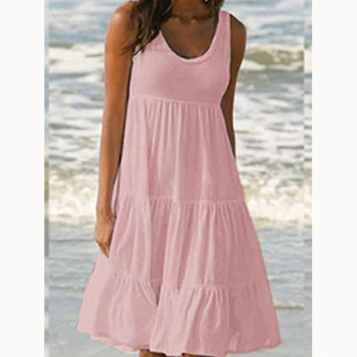 Full-length shot of the Luna tiered midi dress in yellow showing the flowy silhouette against a bright background