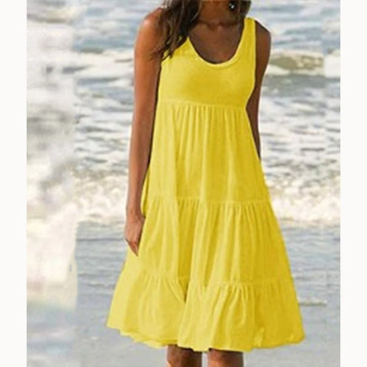 Flat lay of the Luna tiered midi dress showing fabric texture, ruffle tiers, and scoop neckline detail