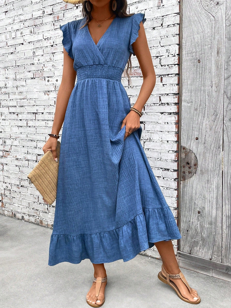 Woman wearing a soft blue V-neck smocked waist ruffle hem maxi dress with flutter sleeves and tiered ruffle hem