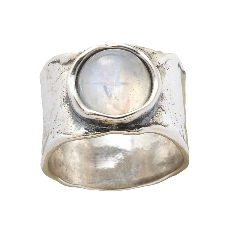 Silver moonstone ring shown from a side angle highlighting the stone's ethereal light reflection