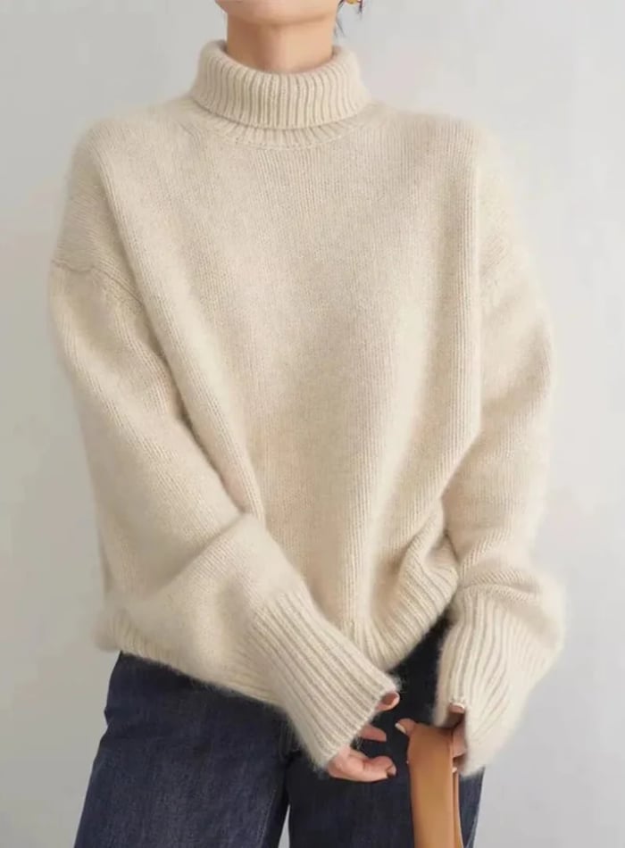 Animated gif showing the soft turtleneck sweater styled casually in off white