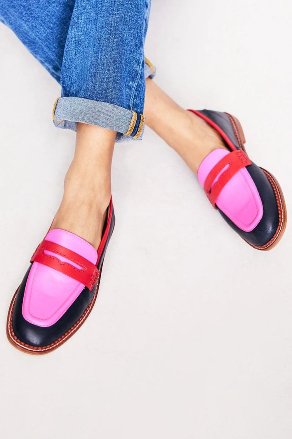 Lunessa black slip-on loafers with a colored accent detail, shown from a front angle on a clean background