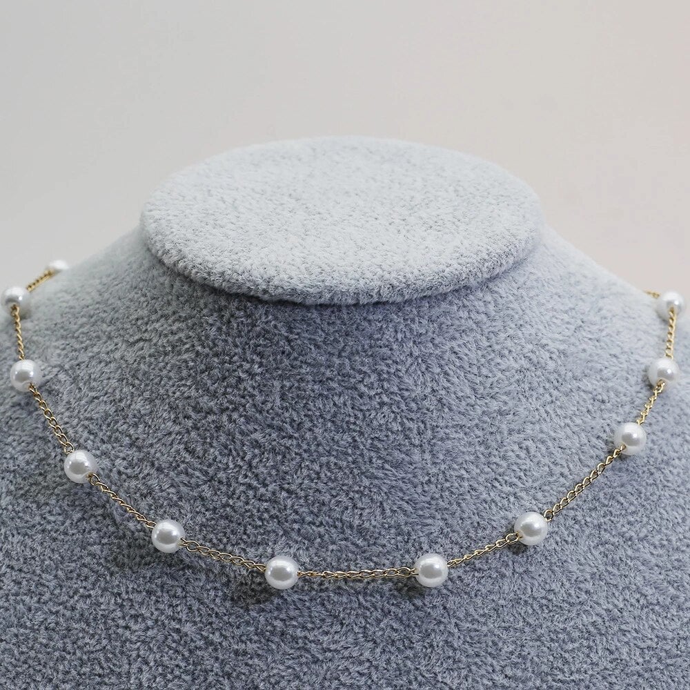 Gold pearl necklace draped elegantly to highlight its lightweight and polished design