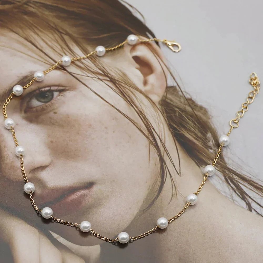 Detail shot of the pearl and gold-tone clasp on a lustrous finish necklace