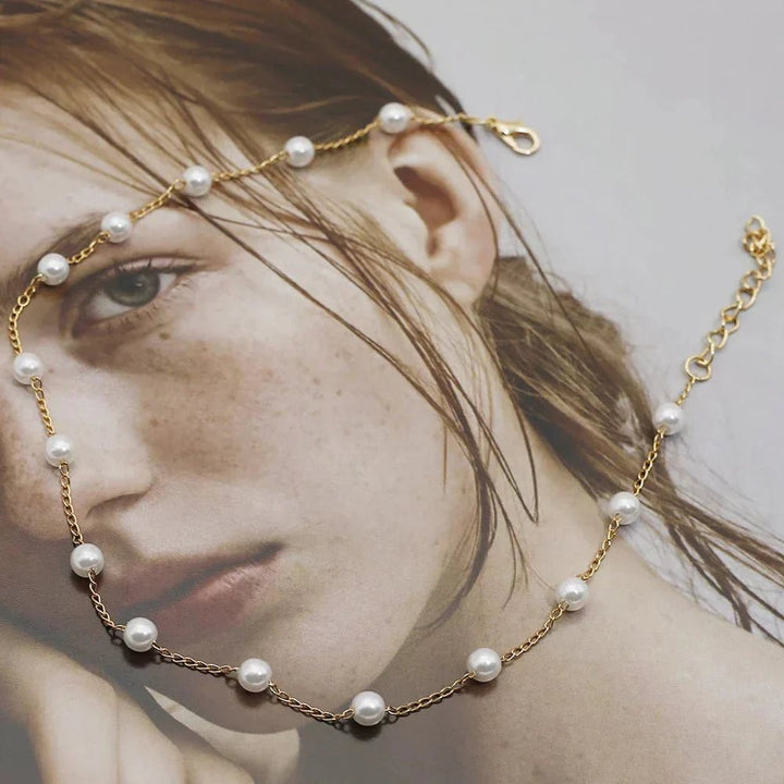 Detail shot of the pearl and gold-tone clasp on a lustrous finish necklace