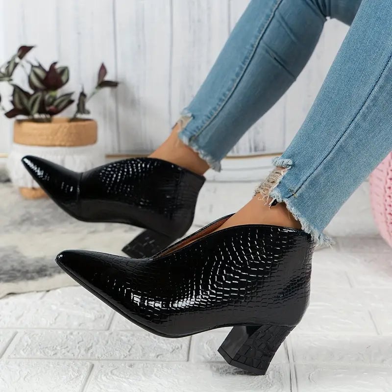 Women's textured ankle boots in black with curved cut and mid block heel, front view
