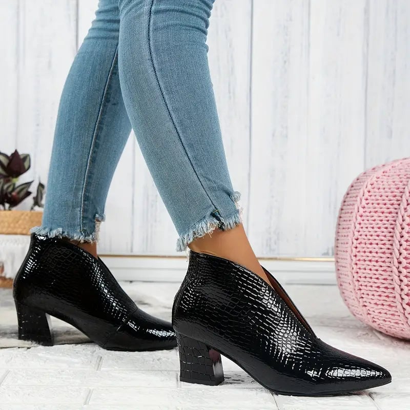 Close-up of textured upper and curved cut detail on women's ankle boots