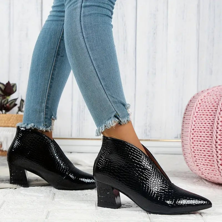 Close-up of textured upper and curved cut detail on women's ankle boots