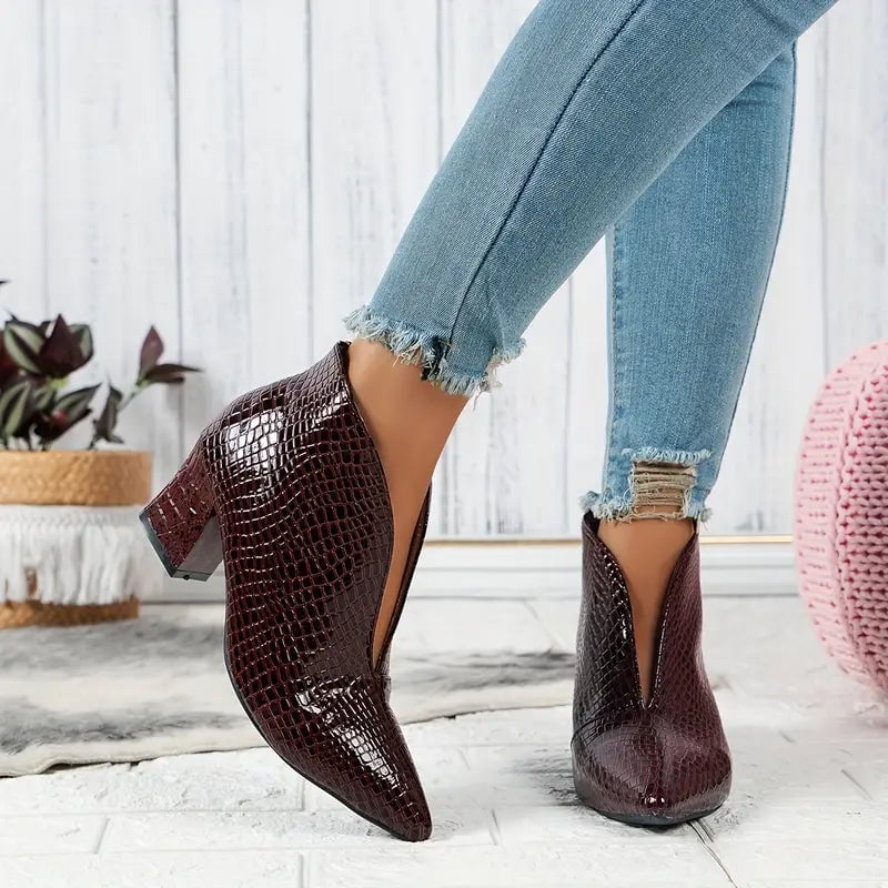 Women's textured ankle boots styled with tailored trousers, full outfit view