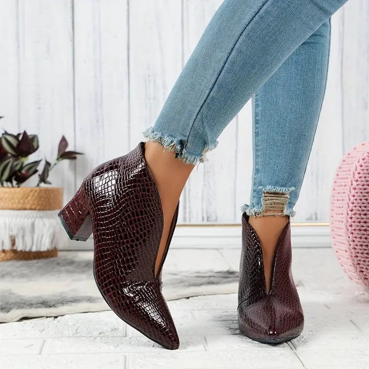 Women's textured ankle boots styled with tailored trousers, full outfit view