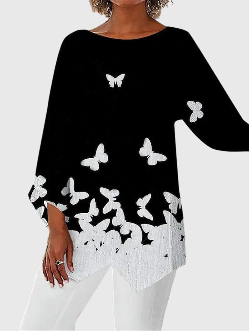 Women's butterfly print top styled with jeans showing full outfit look