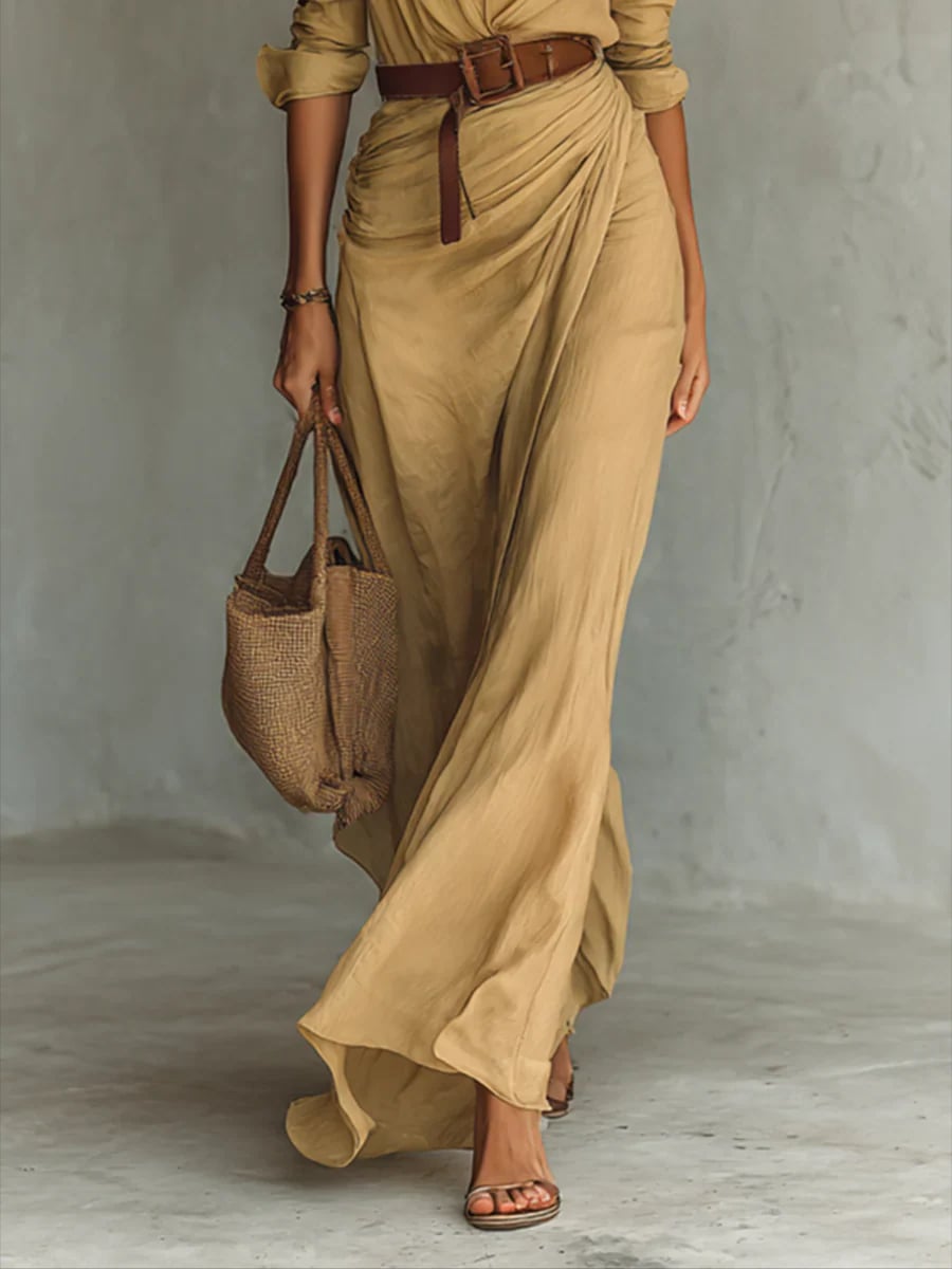 Model wearing the black version of the belted lapel long sleeve maxi dress, full-length view
