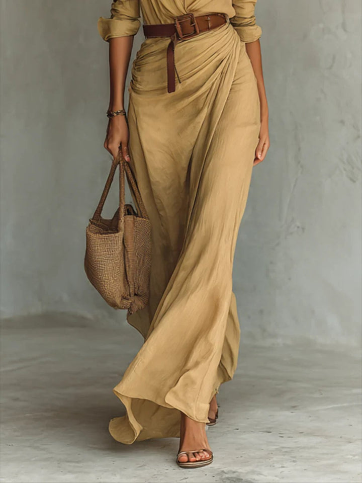 Model wearing the black version of the belted lapel long sleeve maxi dress, full-length view