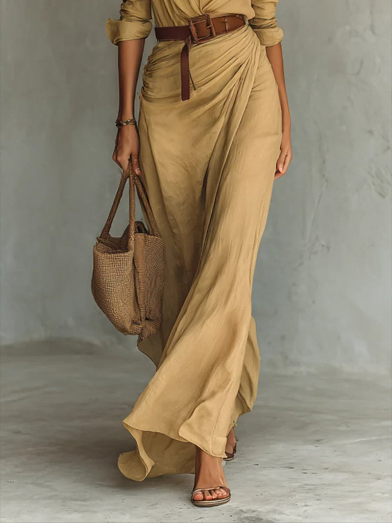 Model wearing the black version of the belted lapel long sleeve maxi dress, full-length view