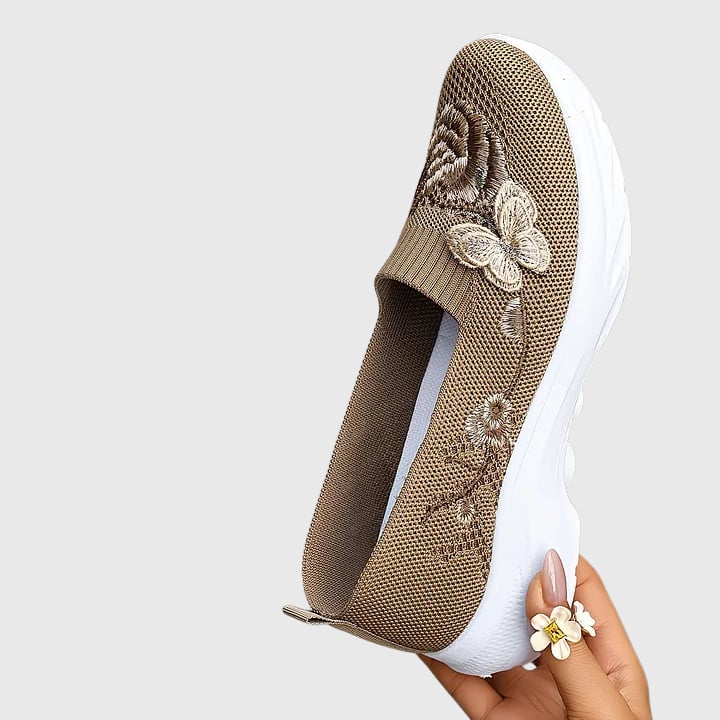 Pair of Lydia butterfly embroidered slip-on sneakers showing all color options: black, green, khaki, and purple