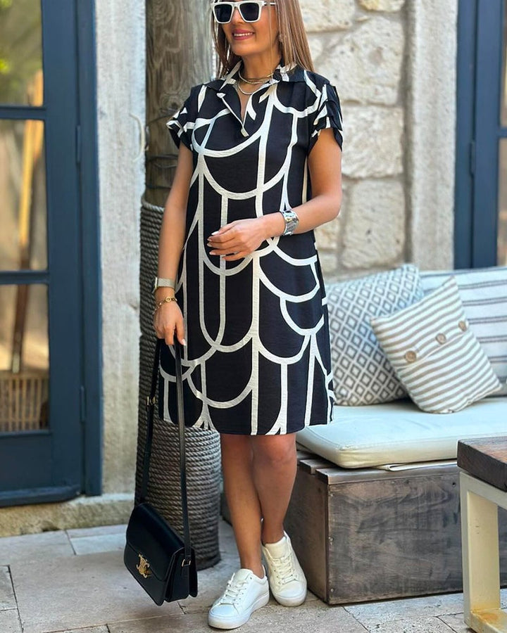 Model wearing the Lynn midi dress styled with heels for an elevated evening look