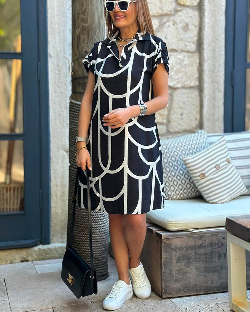 Model wearing the Lynn midi dress styled with heels for an elevated evening look